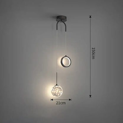 Modern black metal pendant light with gold and black glass globe featuring warm selectable light colors for dining rooms