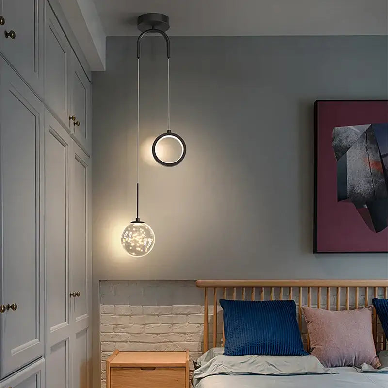 Modern gold and black glass globe pendant light with sleek metal frame and selectable light colors for dining rooms