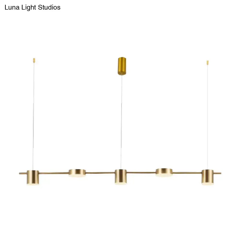 DecorBites modern gold-toned linear chandelier with four cylindrical fixtures offers warm white light and rotatable shades