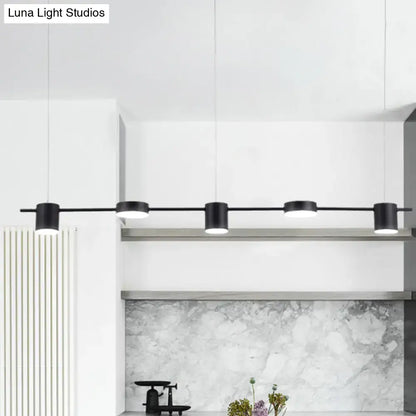 Black DecorBites™ modern cylindrical pendant lights with rotatable shade in warm white light for minimalist kitchen