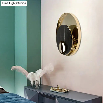 Modern gold and black marble peacock tail feather wall sconce with circular gold frame and black mirrored center wall lamp