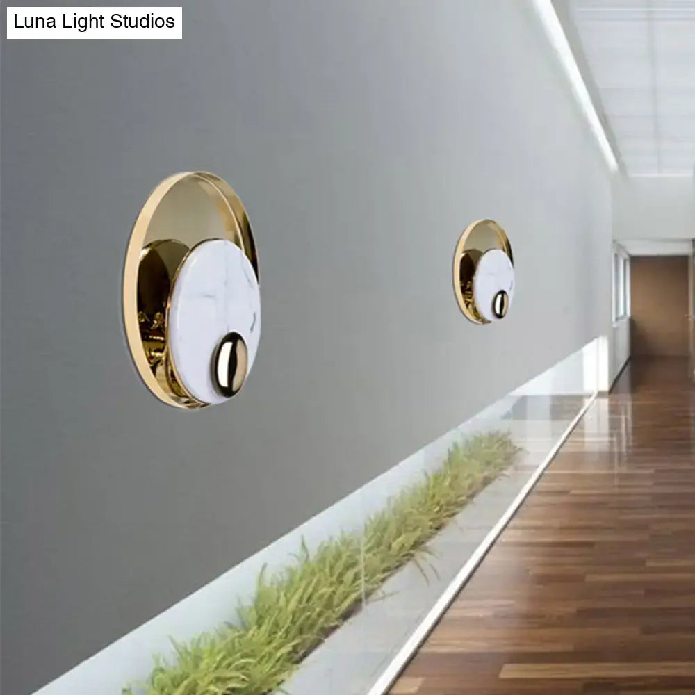 Modern gold wall sconce with black marble peacock tail feather design and white marble face for living room wall lamp