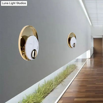 Modern gold wall sconce with black marble peacock tail feather design and white marble face for living room wall lamp