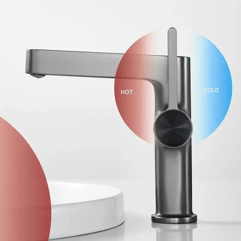 Modern gold and black decorbites basin faucet with matte finish and sleek minimalist design featuring circular control knob