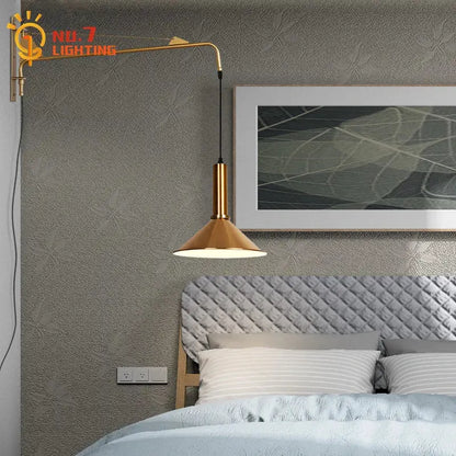 Modern gold and black swing arm wall lamp with gold-toned conical shade and sleek curved arm for bedroom decorbites gold black