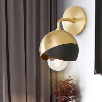 A modern wall lamp with a brushed gold and matte black finish featuring an exposed bulb e26 e27 inch fixture