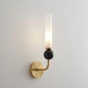 Modern gold and black wall lamp with a copper base and frosted glass shade for elegant living room decor