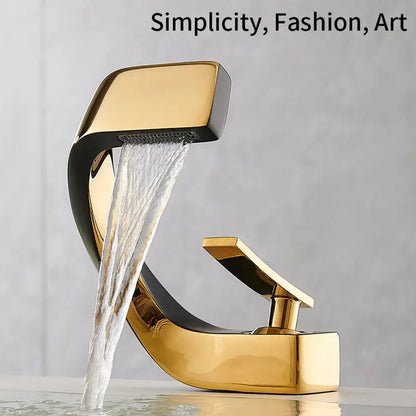 Modern gold and black basin faucet with sleek curved waterfall design for stylish bathroom fixtures