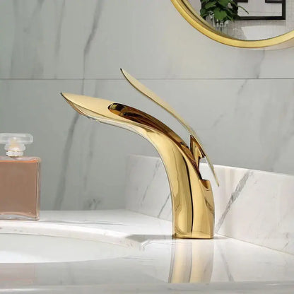 Modern gold brass basin faucet with sleek flowing design for bathroom sink mixer by decorbites brass basin