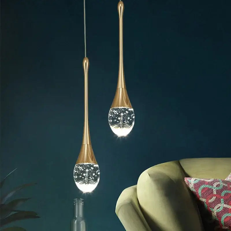 Two elegant gold-toned decorbites bubble crystal pendant lights with teardrop glass globes for dining room decor