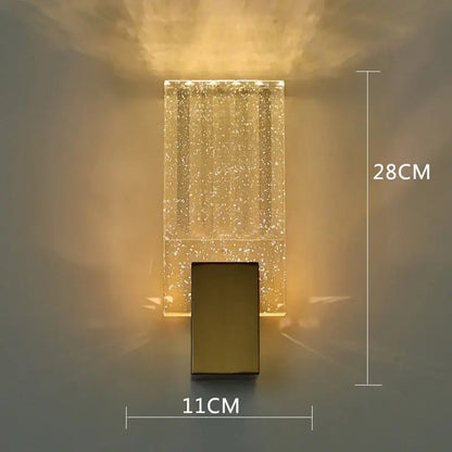 A modern gold bubble crystal led wall sconce with translucent acrylic body and warm ambient light for living rooms