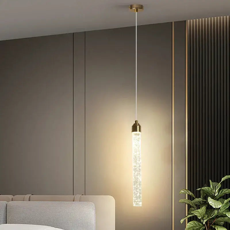 Modern gold bubble crystal pendant light with cylindrical glass body and brass fixtures for dining room lighting