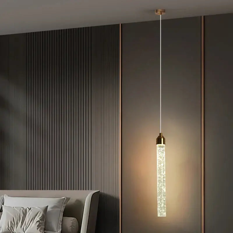 Modern gold bubble crystal pendant light with cylindrical glass body and warm glow for dining room lighting