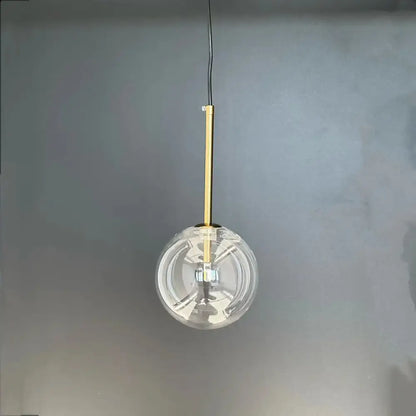 Modern gold bubble glass ball pendant light featuring a clear glass globe and slender gold-toned rod for kitchen decorbites bubble glass
