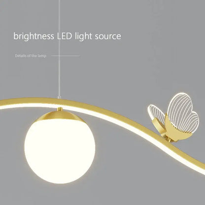 Modern gold butterfly chandelier pendant lamp with spherical frosted glass shade and illuminated butterfly accent for dining room decor