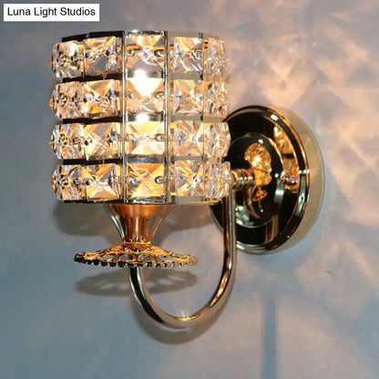 Modern gold butterfly wall light fixture with a crystal shade of clear faceted squares in polished metal for living room