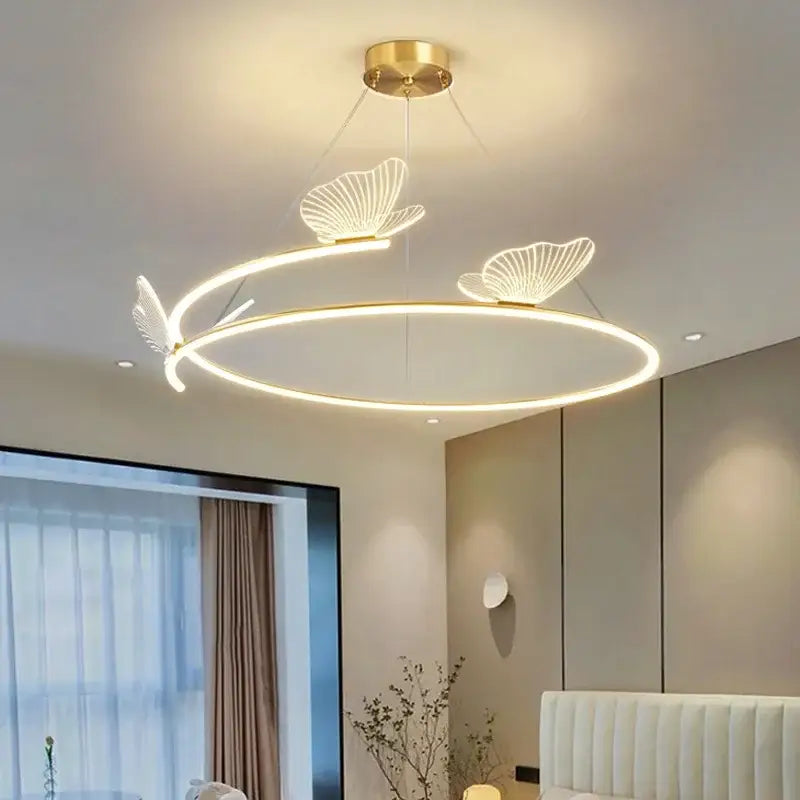 Modern gold butterfly design ceiling chandelier featuring gold-toned circular led with delicate brass butterfly fixtures