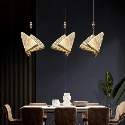 Three elegant gold-toned decorbites butterfly pendant lights with intricate woven mesh detail for luxury bedroom lighting