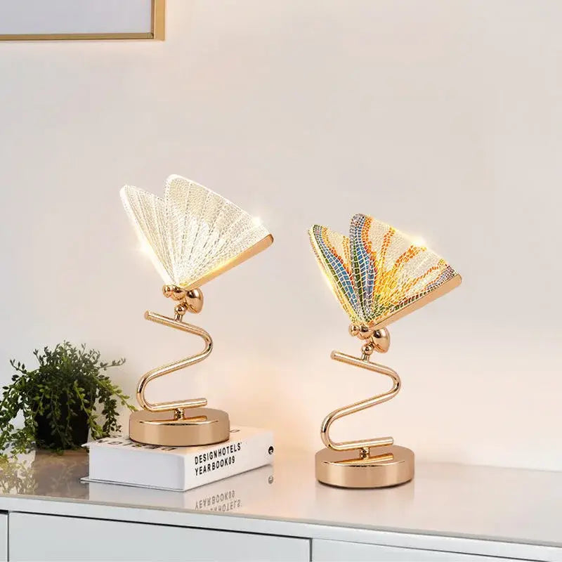 Two gold-toned butterfly pendant lamps with illuminated fan-like wings in clear and colorful mosaic designs for luxury decorbites pendant lights