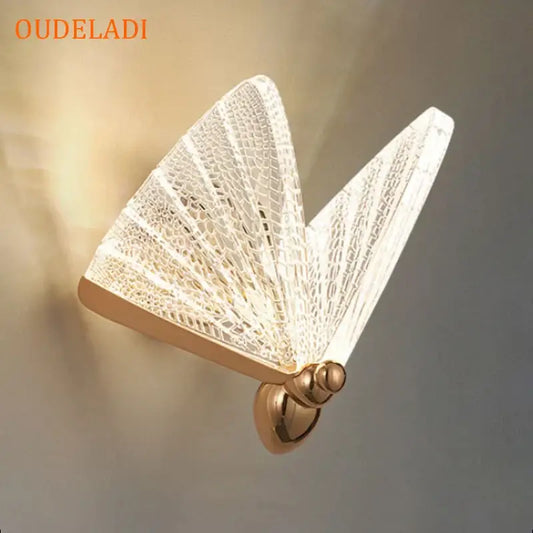 Modern gold butterfly wall lamp with delicate translucent lace detailing and gold-toned metal base for bedroom decorbites butterfly wall lighting