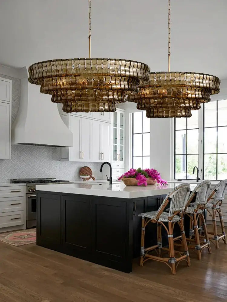 Modern gold cascading crystal pendant lights featuring decorbites brown glass with textured brown glass pendant design above island
