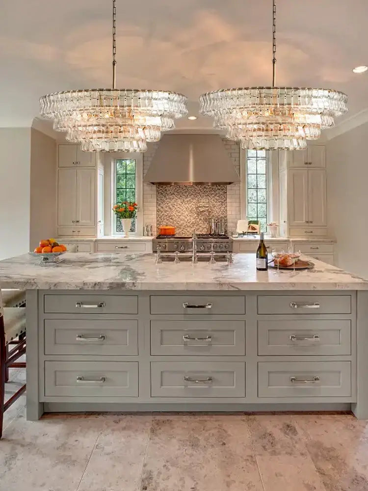 Two large modern gold cascading crystal pendant lights feature multiple tiers of hanging decorbites brown glass pieces