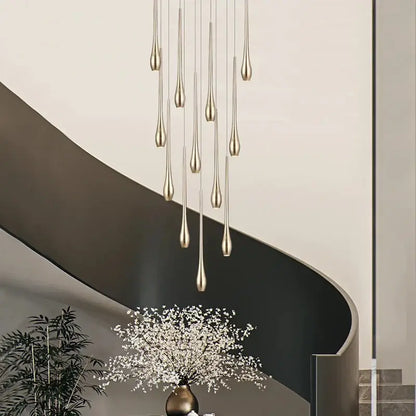 A modern gold-toned led ceiling chandelier with slender teardrop fixtures in a cascading design for living room use