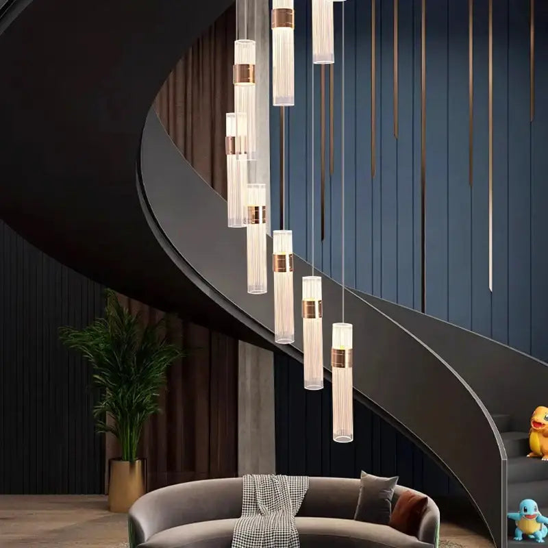 Modern gold cascading pendant light with clear glass cylinders and adjustable height for dining room use