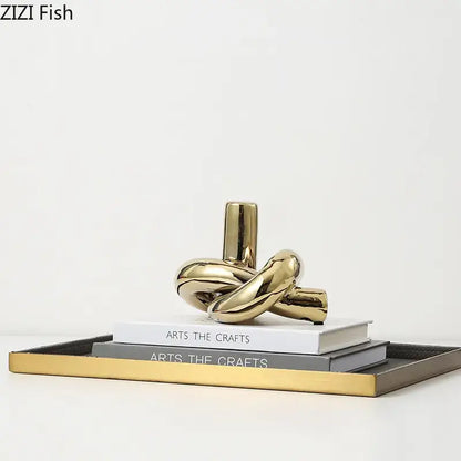 Modern gold ceramic knot sculpture with shiny reflective surfaces for living room decorbites ceramic knot decor