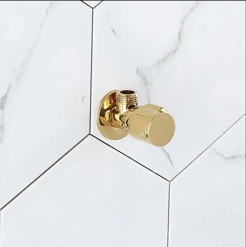 Modern gold and chrome brass triangle valve with sleek brass triangle valve design mounted on white marble decorbites brass
