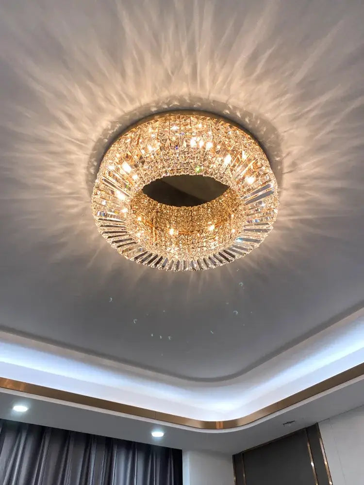 Modern gold and chrome crystal led ceiling lights featuring a circular gold-toned chandelier with radiant light effect