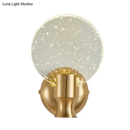 Modern gold circle panel wall light with gold finish and translucent glass shade embedded with white speckles direct wired electric