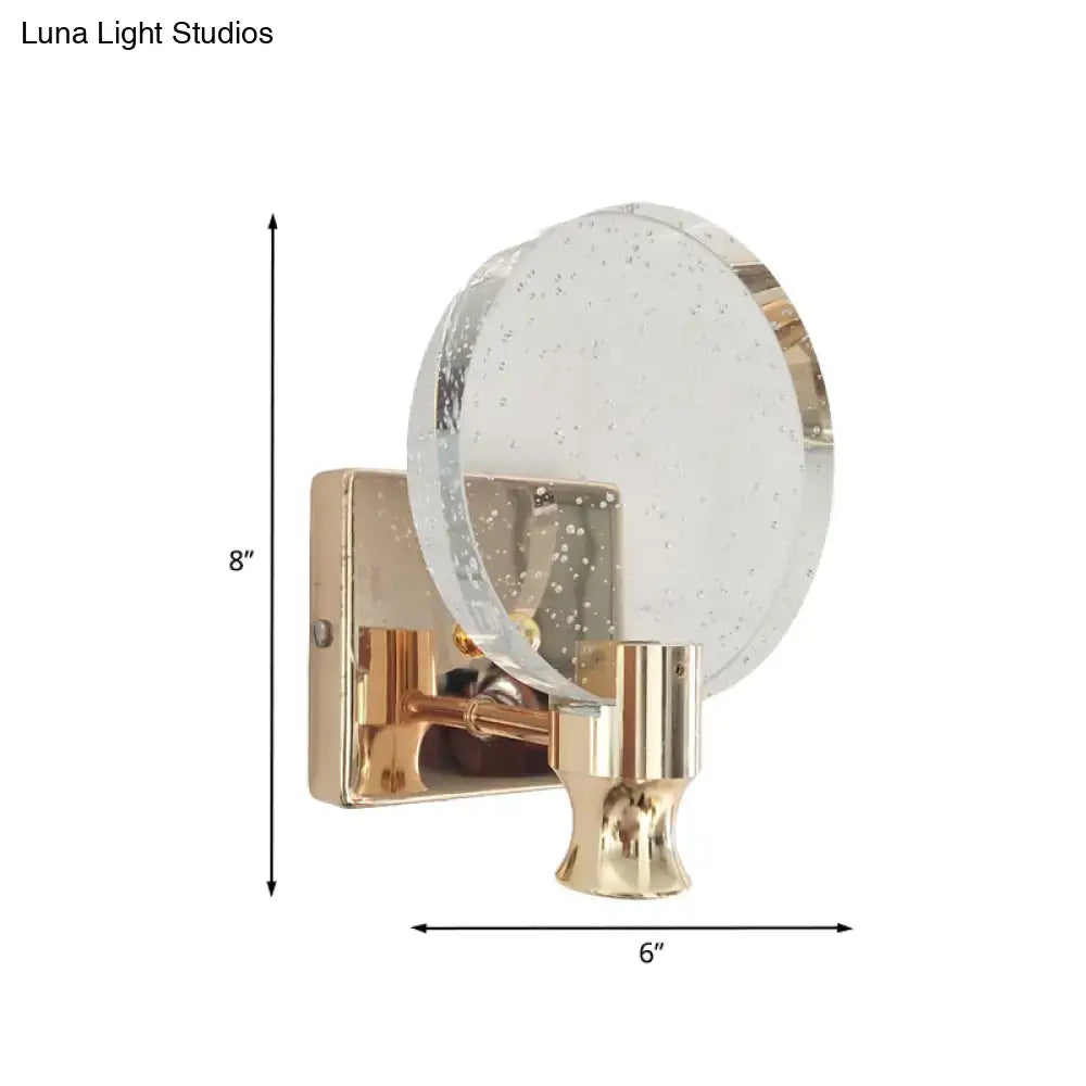 Modern gold circle panel wall light featuring a direct wired electric bubble crystal sconce with textured glass disc