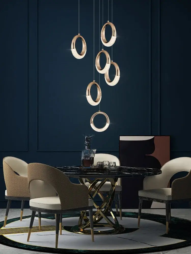 Modern gold circle ring led chandelier with crystal accents cascades as pendant lights above dining table decorbites circle ring