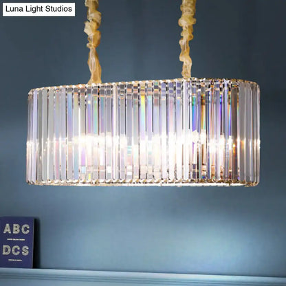 Modern gold clear crystal island chandelier with rectangular vertical rods refracting light for dining room use