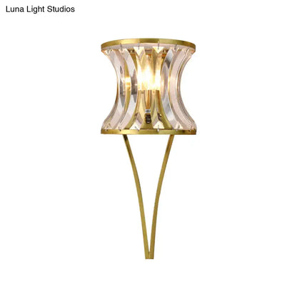Elegant gold-toned modern wall sconce with a curved clear crystal shade for 110v-120v and 220v-240v living room lighting