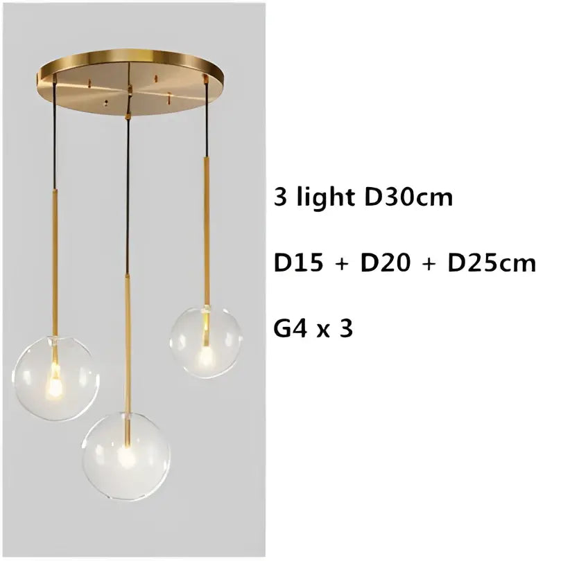 Modern gold pendant light with brass finish and three varying clear glass globe shades for dining room decorbites clear glass