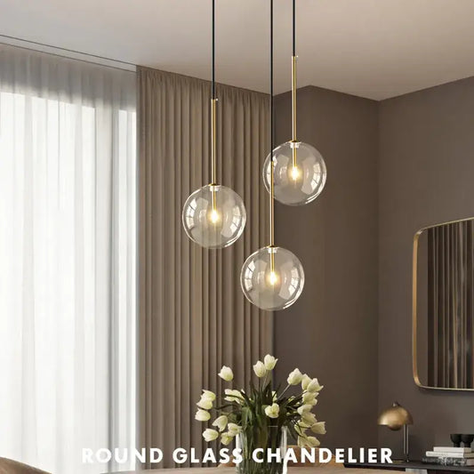 Modern gold clear glass globe pendant light featuring a round glass chandelier with gold-toned metal accents decorbites clear glass