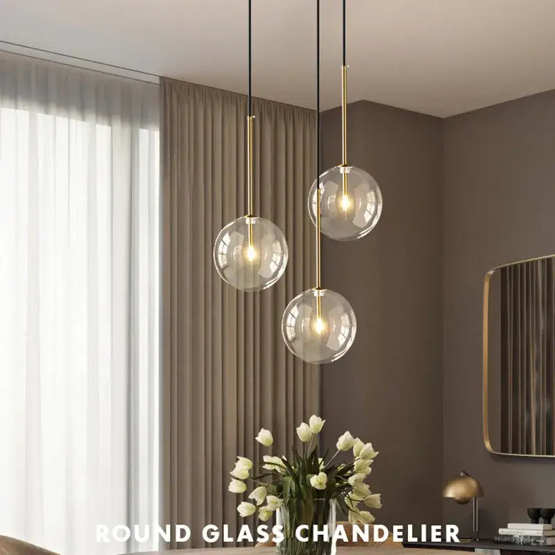 Modern gold clear glass globe pendant light featuring a round glass chandelier with gold-toned metal accents decorbites clear glass