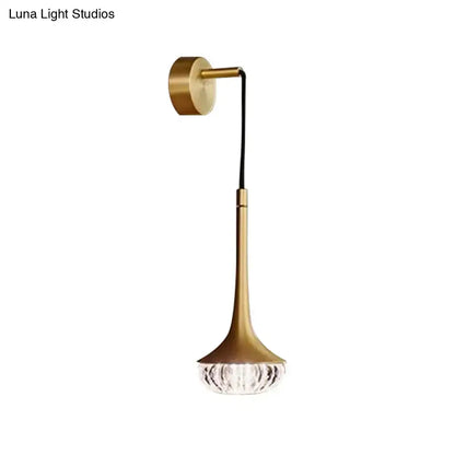 Modern gold clear textured glass wall sconce with sleek stem and faceted crystal base for living room lighting