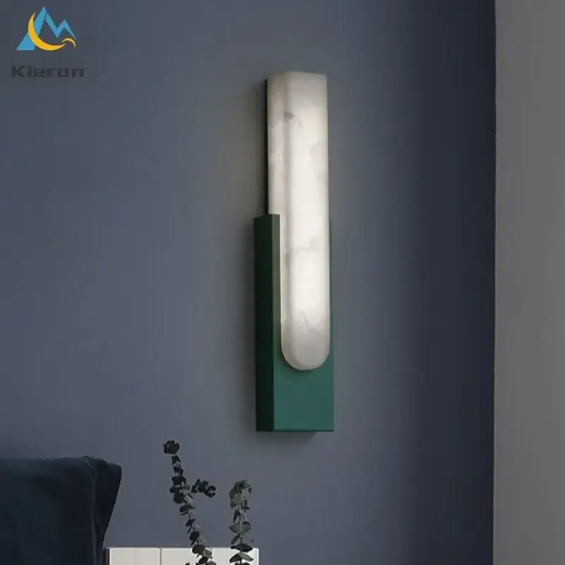 Modern gold cloud stone led wall light with sleek matte green metal frame and illuminated white marble-like diffuser
