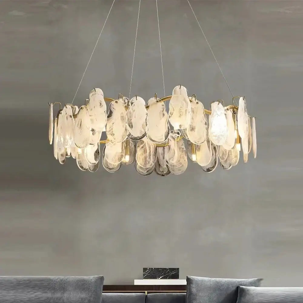 Modern gold cloudy glass chandelier featuring translucent irregular glass discs for elegant living room lighting decorbites cloudy glass