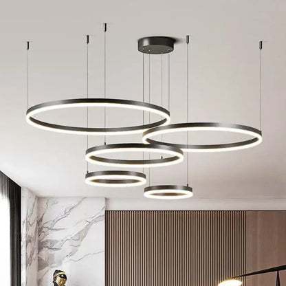 Modern black circular led pendant chandelier with glowing white brushed rings for dining room lighting