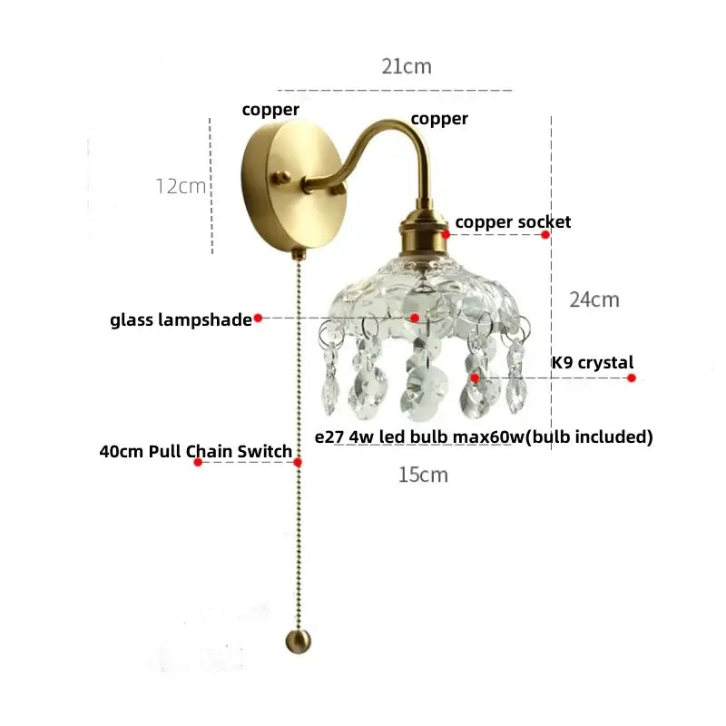 Antique brass-finished wall light fixture with clear glass lampshade and dangling k9 crystals for bedroom use