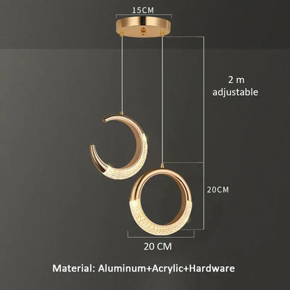 Modern gold pendant light with crescent and circular design featuring sparkling acrylic accents for dining settings