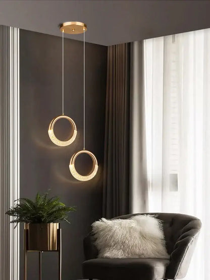 Modern gold crescent pendant light made of high-quality french metal with a minimalist design for dining settings