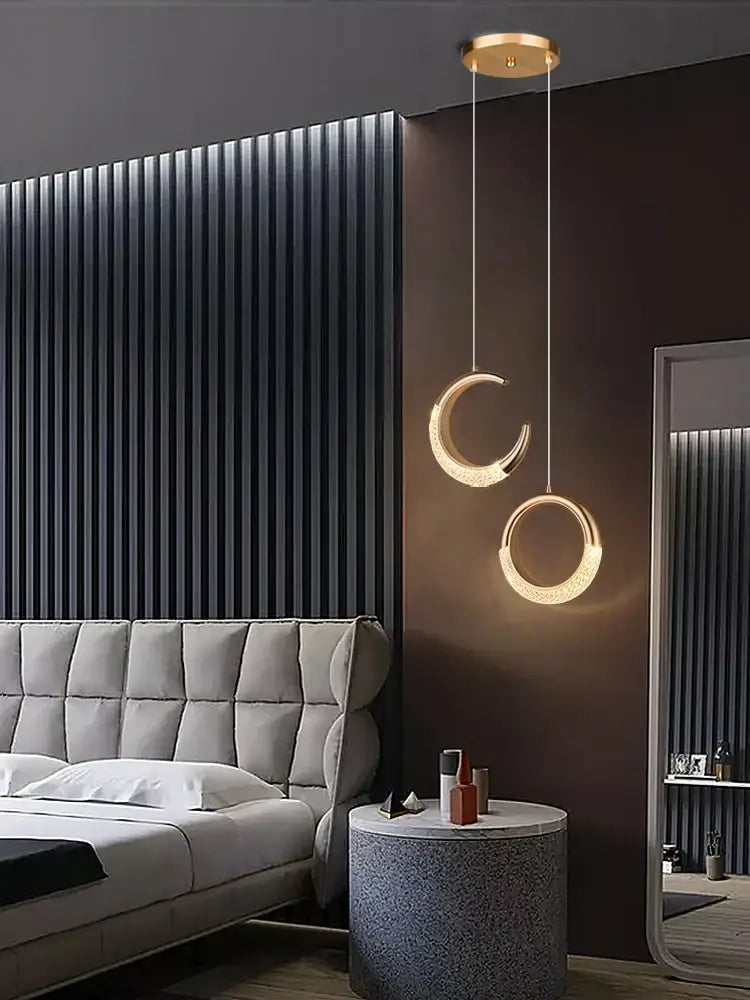 Modern gold crescent pendant light made of high-quality french metal with circular led rings for dining settings