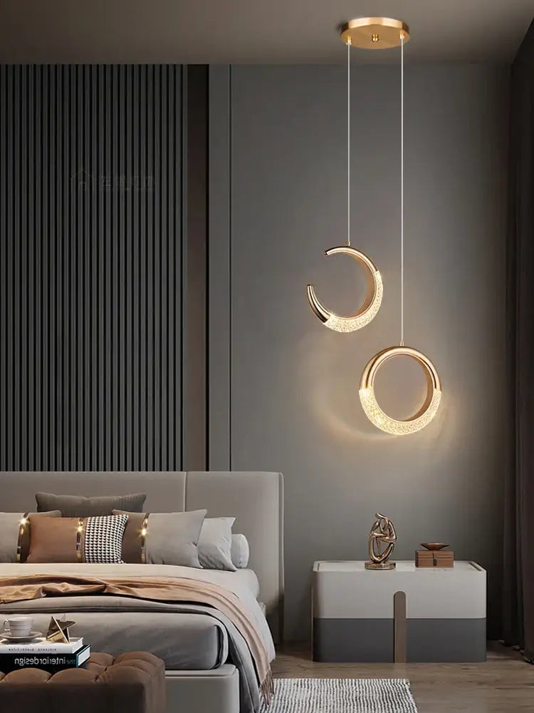 Modern gold crescent pendant light with high-quality french metal and crystal accents for elegant dining settings