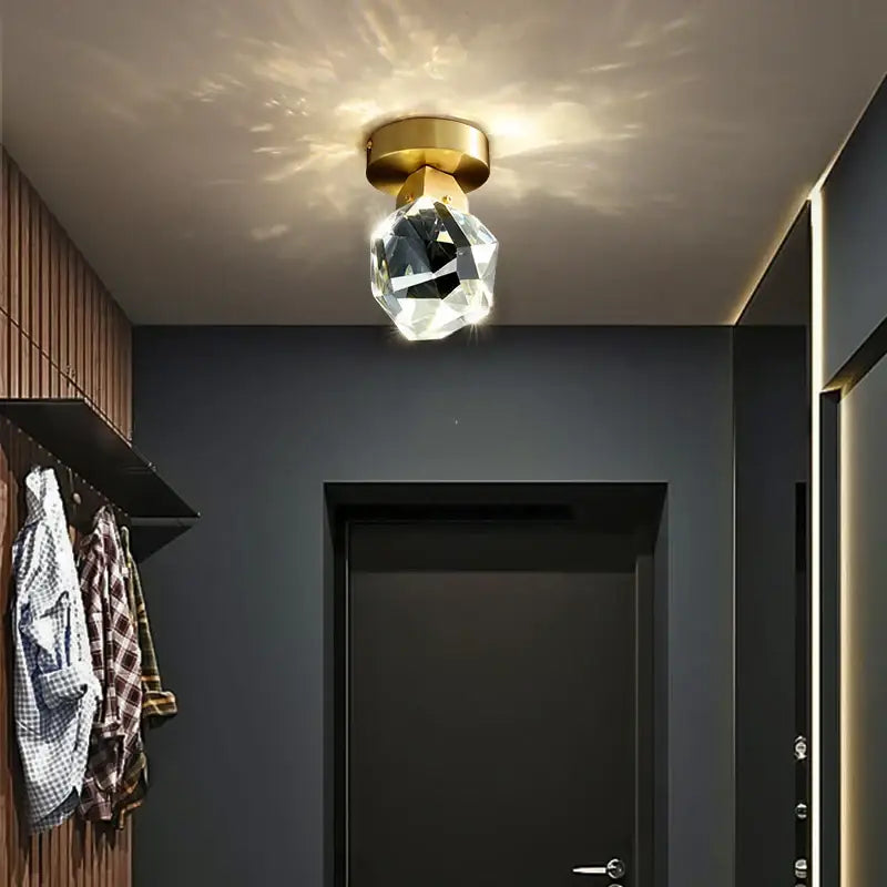 Modern gold crystal aisle ceiling light featuring a faceted crystal pendant and gold-toned ceiling mount for hallways