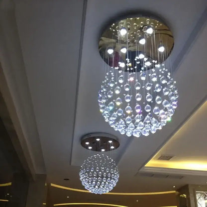 Modern gold crystal ball led chandelier with a circular mirrored base and dangling clear glass orbs for dining room decorbites crystal ball
